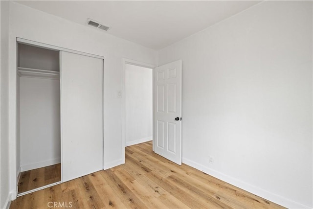 10931 S Burl Ave, Inglewood, CA 90304 - unfurnished bedroom with wood finished floors and a closet