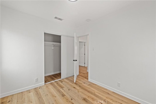 10931 S Burl Ave, Inglewood, CA 90304 - unfurnished bedroom with light wood-style floors and a closet