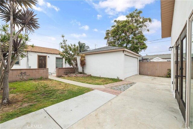 10931 S Burl Ave, Inglewood, CA 90304 - view of green lawn with concrete driveway, an outdoor structure, and a garage