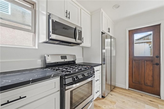 10931 S Burl Ave, Inglewood, CA 90304 - kitchen with stainless steel appliances, white cabinets, and light wood-style flooring