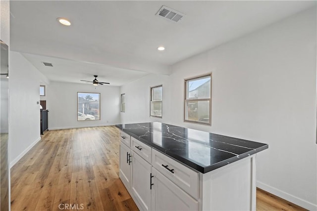 10931 S Burl Ave, Inglewood, CA 90304 - kitchen featuring white cabinets, a ceiling fan, light wood finished floors, a kitchen island, and open floor plan