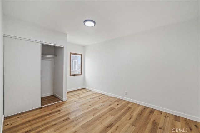 10931 S Burl Ave, Inglewood, CA 90304 - unfurnished bedroom with light wood-style flooring and a closet