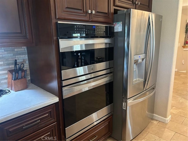 5995 W Brooks Rd, Merced, CA 95341 - kitchen featuring appliances with stainless steel finishes, light countertops, backsplash, and dark brown cabinetry