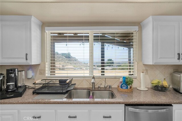 20605 Broadview Dr, Perris, CA 92570 - kitchen with stainless steel dishwasher, a sink, white cabinets, and backsplash