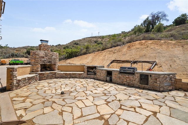 20605 Broadview Dr, Perris, CA 92570 - view of patio featuring a stone fireplace