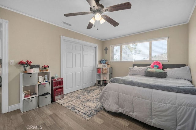 20605 Broadview Dr, Perris, CA 92570 - bedroom featuring wood finished floors, ornamental molding, a closet, and ceiling fan