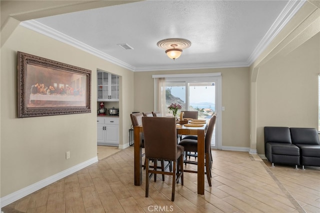 20605 Broadview Dr, Perris, CA 92570 - dining space featuring ornamental molding, light wood-style flooring, baseboards, and a textured ceiling