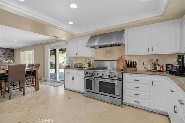 20605 Broadview Dr, Perris, CA 92570 - kitchen featuring wall chimney range hood, range with two ovens, tasteful backsplash, ornamental molding, and white cabinetry