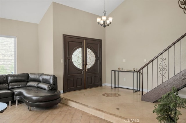20605 Broadview Dr, Perris, CA 92570 - foyer entrance featuring a chandelier, stairway, baseboards, and high vaulted ceiling
