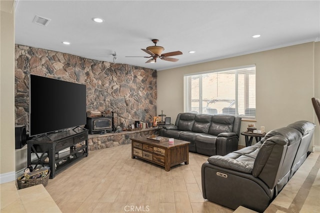 20605 Broadview Dr, Perris, CA 92570 - living area featuring a wood stove, a ceiling fan, recessed lighting, crown molding, and light wood finished floors