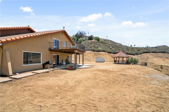 20605 Broadview Dr, Perris, CA 92570 - back of property featuring a gazebo, a tiled roof, stucco siding, and a patio area