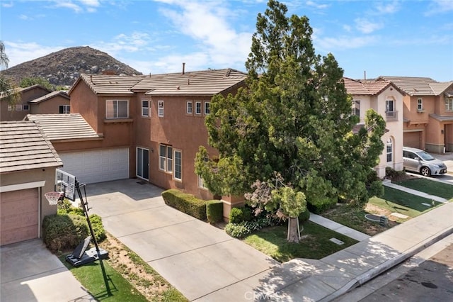 3762 Almansa Way, Perris, CA 92571 - view of front of home with stucco siding, concrete driveway, a garage, a residential view, and a tile roof