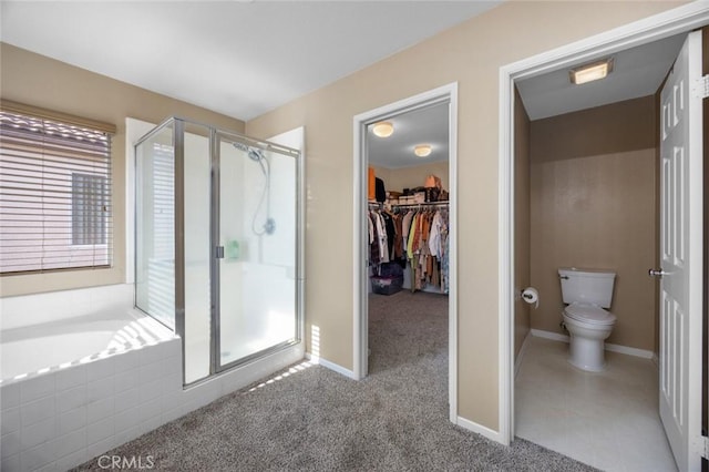 3762 Almansa Way, Perris, CA 92571 - bathroom featuring a shower stall, toilet, a garden tub, baseboards, and a walk in closet