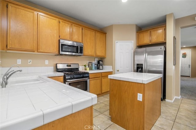 3762 Almansa Way, Perris, CA 92571 - kitchen with appliances with stainless steel finishes, tile countertops, a sink, light tile patterned flooring, and a kitchen island