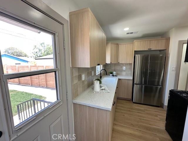 2510 Termino Ave, Long Beach, CA 90815 - kitchen featuring freestanding refrigerator, light brown cabinets, light countertops, decorative backsplash, and light wood-style floors
