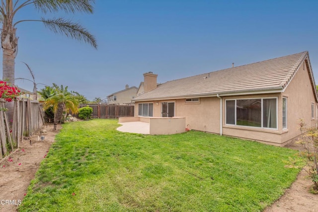 1724 Hilaria St, Oxnard, CA 93030 - rear view of house with stucco siding, a tile roof, a chimney, and a patio area