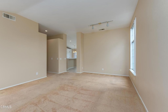 1724 Hilaria St, Oxnard, CA 93030 - empty room featuring light colored carpet, rail lighting, baseboards, and recessed lighting