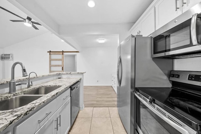 2920 Briarwood Rd Unit G12, Bonita, CA 91902 - kitchen with appliances with stainless steel finishes, a sink, white cabinetry, a ceiling fan, and light tile patterned floors
