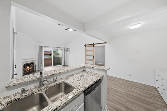 2920 Briarwood Rd Unit G12, Bonita, CA 91902 - kitchen featuring stainless steel dishwasher, wood finished floors, a sink, baseboards, and a tiled fireplace