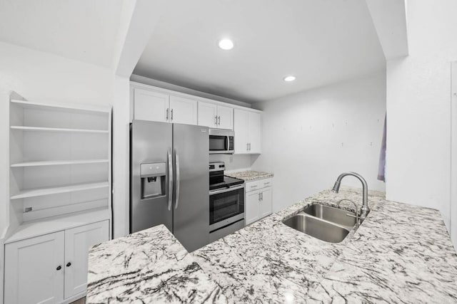 2920 Briarwood Rd Unit G12, Bonita, CA 91902 - kitchen with appliances with stainless steel finishes, a sink, white cabinets, light stone counters, and recessed lighting