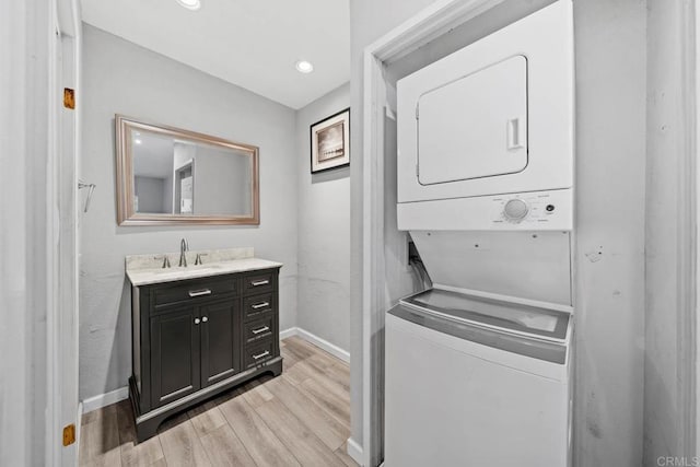 2920 Briarwood Rd Unit G12, Bonita, CA 91902 - laundry area featuring stacked washer / dryer, light wood finished floors, baseboards, and recessed lighting