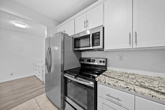 2920 Briarwood Rd Unit G12, Bonita, CA 91902 - kitchen with appliances with stainless steel finishes, white cabinetry, and light stone countertops