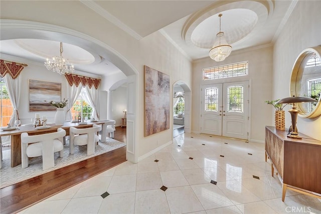 1768 Oakwood Ave, Arcadia, CA 91006 - foyer entrance featuring arched walkways, a chandelier, light tile patterned floors, crown molding, and french doors