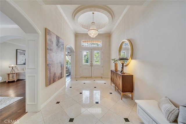 1768 Oakwood Ave, Arcadia, CA 91006 - foyer featuring arched walkways, crown molding, light tile patterned floors, baseboards, and french doors