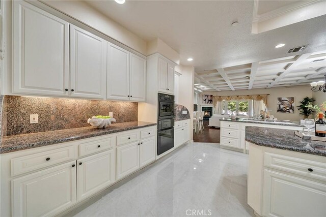 1768 Oakwood Ave, Arcadia, CA 91006 - kitchen with coffered ceiling, recessed lighting, tasteful backsplash, dark stone counters, and white cabinets