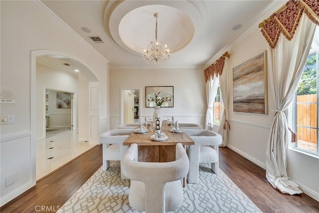 1768 Oakwood Ave, Arcadia, CA 91006 - dining space with arched walkways, wood finished floors, a chandelier, ornamental molding, and baseboards