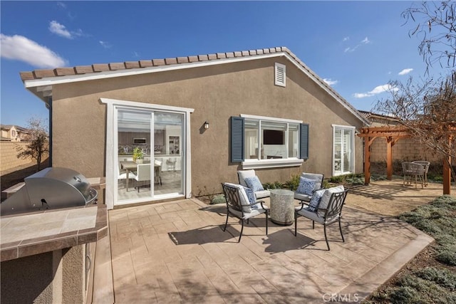 13897 Mesa View Dr, Victorville, CA 92392 - rear view of property featuring a patio area, an outdoor kitchen, stucco siding, and a pergola