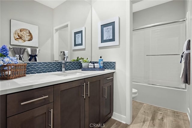 13897 Mesa View Dr, Victorville, CA 92392 - full bath featuring vanity, wood finished floors, toilet, shower / washtub combination, and baseboards