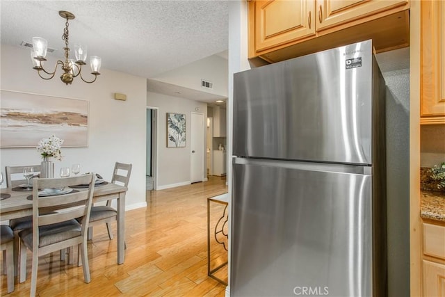 366 Elderberry St, La Verne, CA 91750 - dining space featuring a chandelier, light wood finished floors, a textured ceiling, baseboards, and lofted ceiling