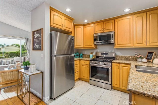 366 Elderberry St, La Verne, CA 91750 - kitchen featuring stainless steel appliances, light tile patterned floors, light stone counters, recessed lighting, and vaulted ceiling