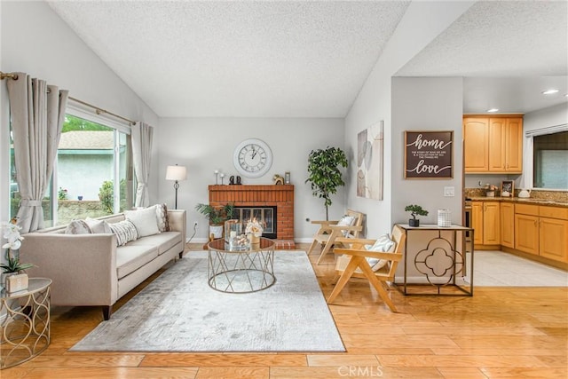 366 Elderberry St, La Verne, CA 91750 - living area with a textured ceiling, light wood finished floors, a brick fireplace, and recessed lighting