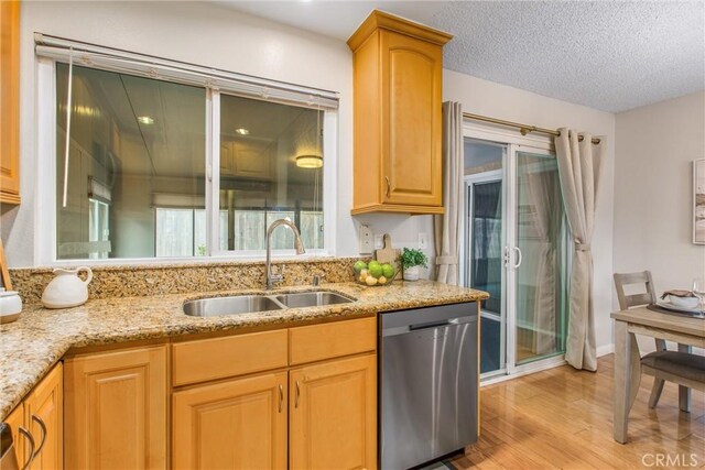 366 Elderberry St, La Verne, CA 91750 - kitchen with stainless steel dishwasher, a sink, light wood-type flooring, light stone counters, and a textured ceiling