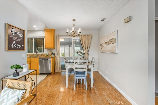 366 Elderberry St, La Verne, CA 91750 - dining space with a chandelier, light wood finished floors, a textured ceiling, and baseboards