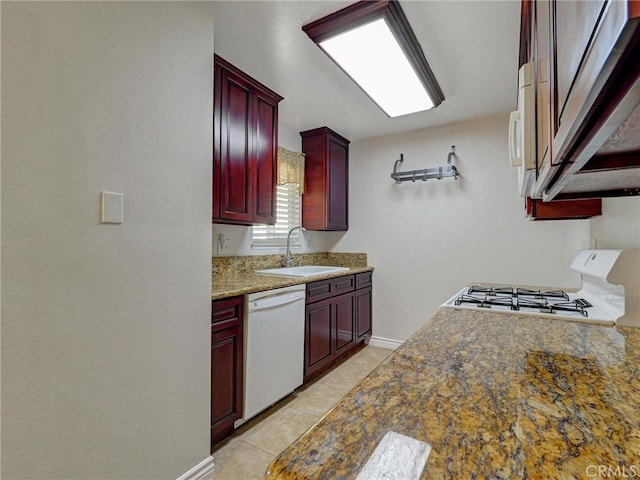8990 19th St Unit 426, Rancho Cucamonga, CA 91701 - kitchen with reddish brown cabinets, white appliances, a sink, baseboards, and light tile patterned floors