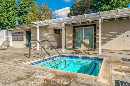 8990 19th St Unit 426, Rancho Cucamonga, CA 91701 - view of swimming pool with a hot tub, a pergola, a patio, and a swimming pool