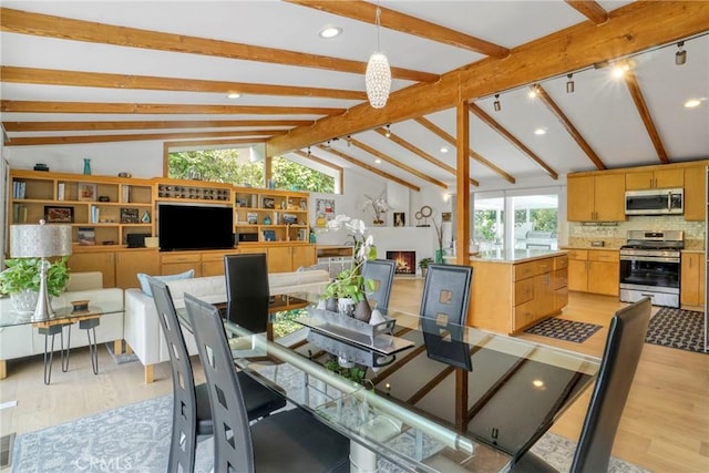 3839 Davana Rd, Sherman Oaks, CA 91423 - dining area with light wood-style flooring, a warm lit fireplace, and recessed lighting