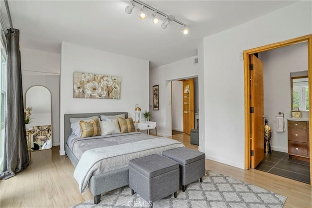 3839 Davana Rd, Sherman Oaks, CA 91423 - bedroom featuring light wood finished floors, track lighting, and baseboards