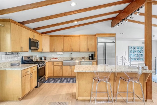 3839 Davana Rd, Sherman Oaks, CA 91423 - kitchen featuring stainless steel appliances, a sink, light wood-style flooring, backsplash, and a center island