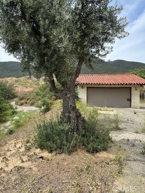 28450 6th St, Temecula, CA 92590 - view of side of home with stucco siding, an outdoor structure, and a tile roof