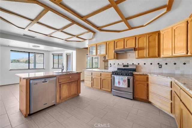 16635 Wintun Rd, Apple Valley, CA 92307 - kitchen with stainless steel appliances, a sink, under cabinet range hood, and tasteful backsplash
