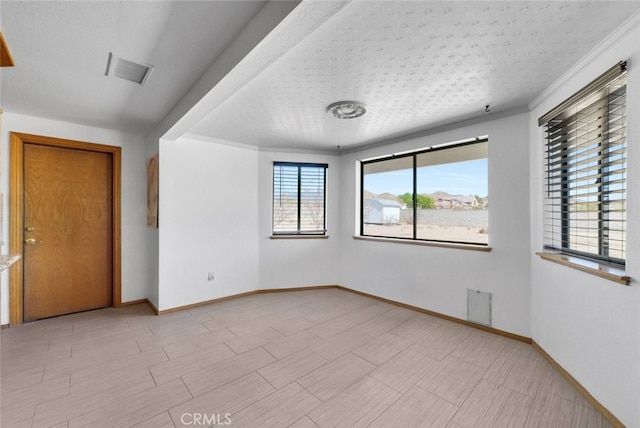 16635 Wintun Rd, Apple Valley, CA 92307 - empty room featuring ornamental molding, baseboards, and a textured ceiling