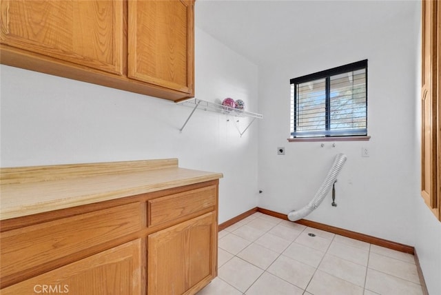 16635 Wintun Rd, Apple Valley, CA 92307 - washroom featuring hookup for an electric dryer, cabinet space, baseboards, and light tile patterned floors