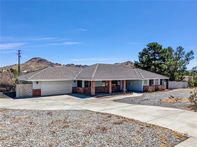 16635 Wintun Rd, Apple Valley, CA 92307 - ranch-style house featuring a garage, concrete driveway, brick siding, and a tiled roof