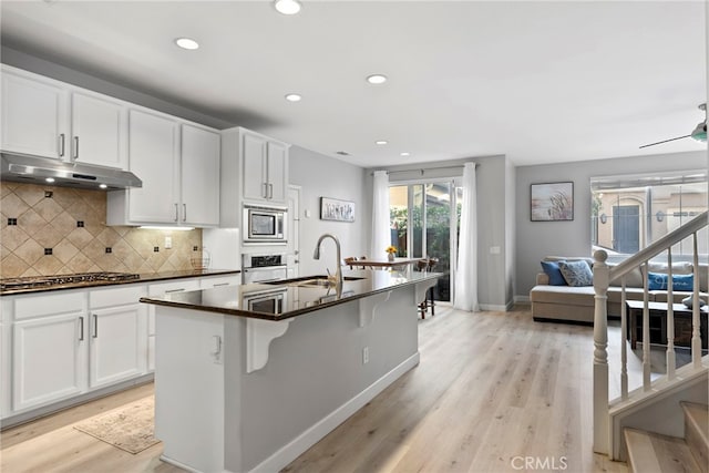 341 W Pebble Creek Ln, Orange, CA 92865 - kitchen with appliances with stainless steel finishes, under cabinet range hood, a sink, dark countertops, and recessed lighting