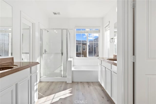 341 W Pebble Creek Ln, Orange, CA 92865 - bathroom with vanity, a stall shower, wood finished floors, and a bath