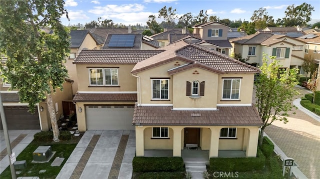 341 W Pebble Creek Ln, Orange, CA 92865 - view of front of house featuring stucco siding, concrete driveway, a porch, and an attached garage